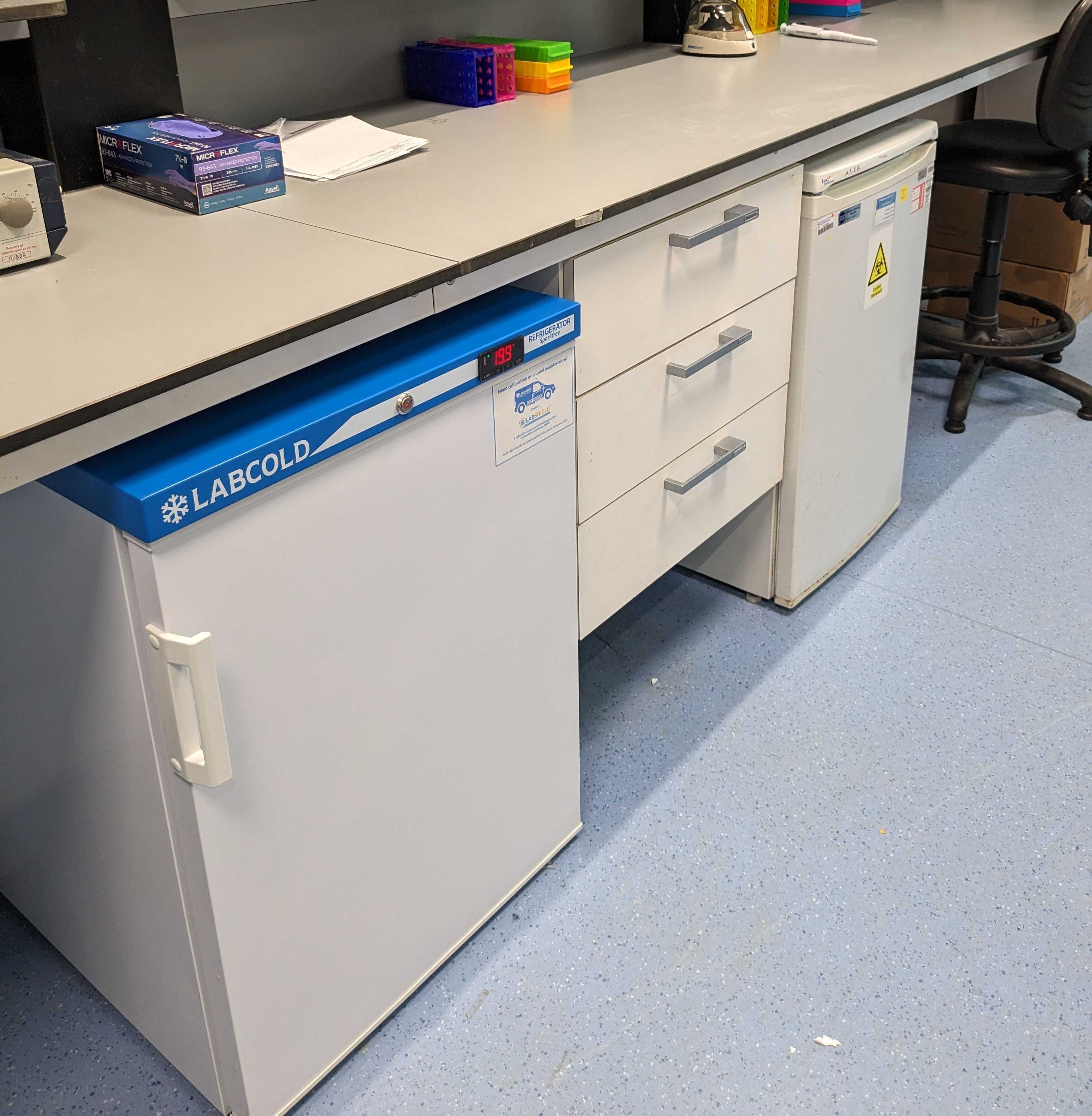 Picture of a newly set up lab and a fridge